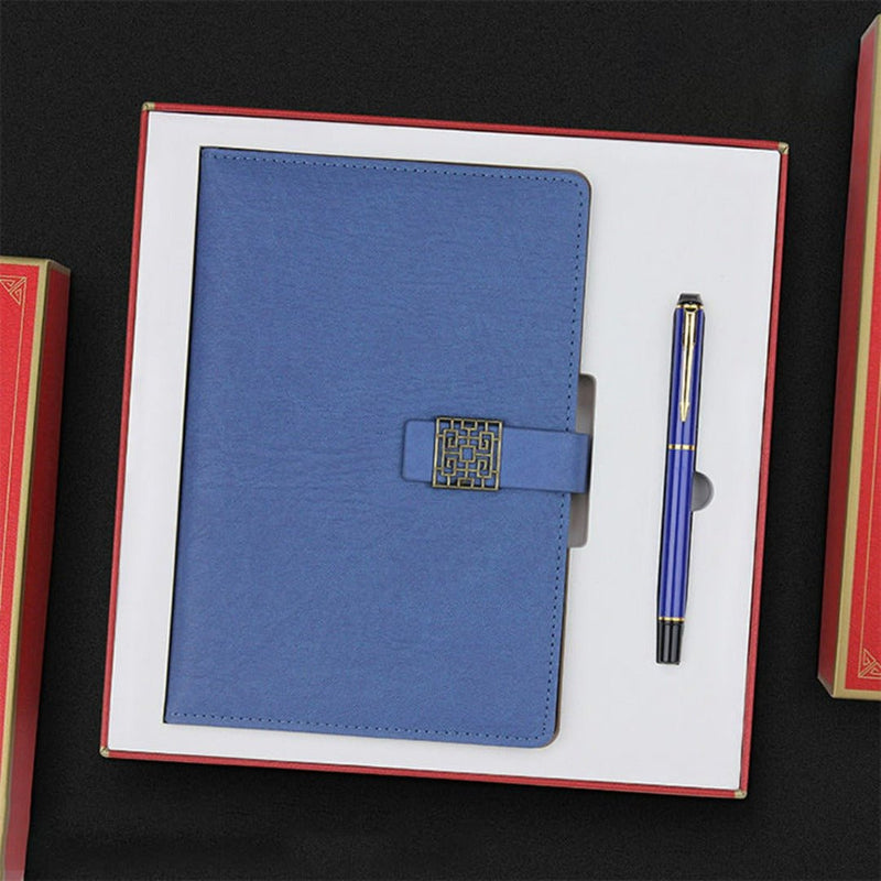 Laad afbeelding in Galerijviewer, Verleid uw partners: Luxe geschenkset voor professionals van hoogwaardig leer met een metallic sluiting naast een blauwe, duurzame pen, aanwezig op een zwarte achtergrond met.
