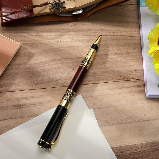 Een elegante Verleidelijke luxe balpen met een comfortabele grip, rustend op een stuk papier op een houten bureau, vergezeld van kantoorbenodigdheden en een notitieboekje.