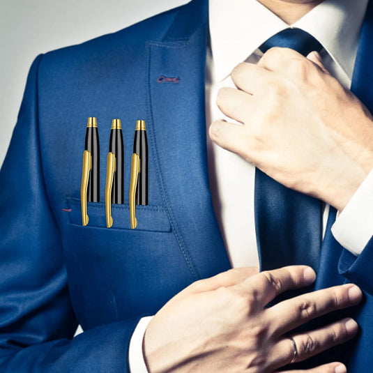 Een persoon in een blauw pak met een elegante Verleidelijke schrijfervaring: 3 metalen balpennen voor een praktische luxe set in de borstzak, die hun das aanpast.